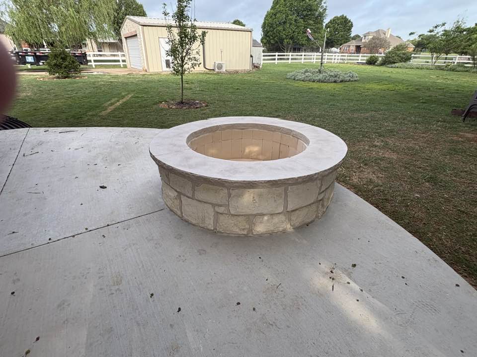 Close-up of finished stone fire pit on concrete patio